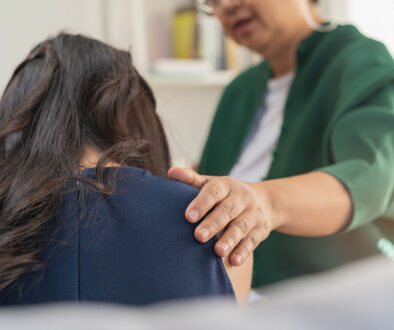 Closeup Of A Grief Counselor Placing Her Hand On A Woman’s Shoulder Work Through The Grieving Process