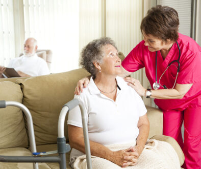 A Senior Woman Sitting On The Couch Being Comforted By A Hospice Caregiver Hospice Care For Dementia